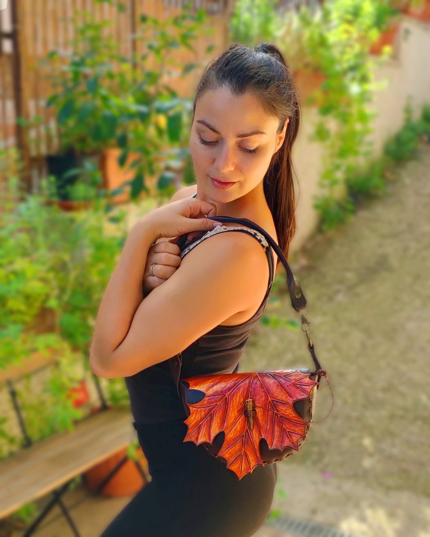 Lifestyle image showing the maple leaf leather bag being carried outdoors, highlighting its practicality and style