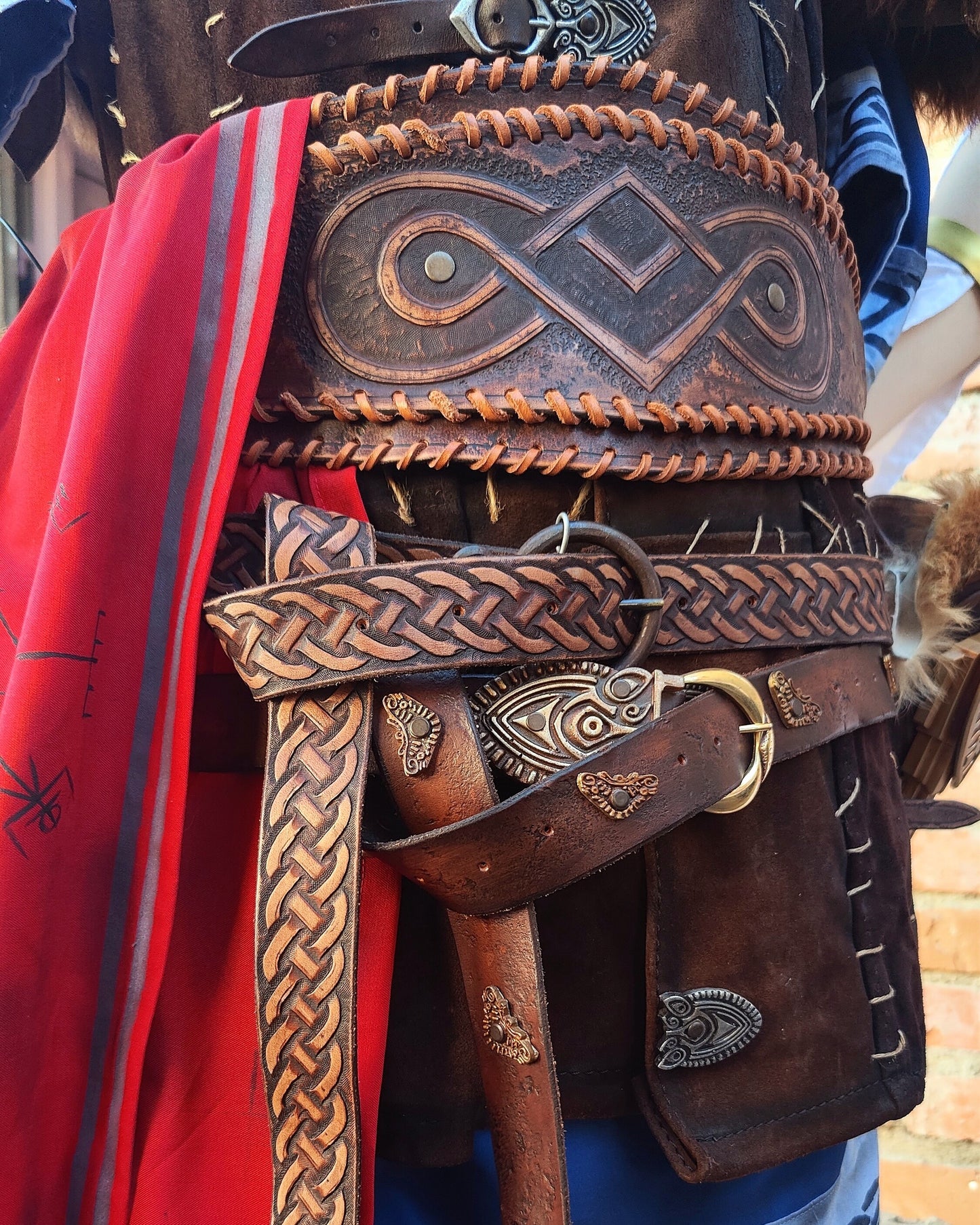 A close up to Eivor's leather belts. Handmade and hand engraved