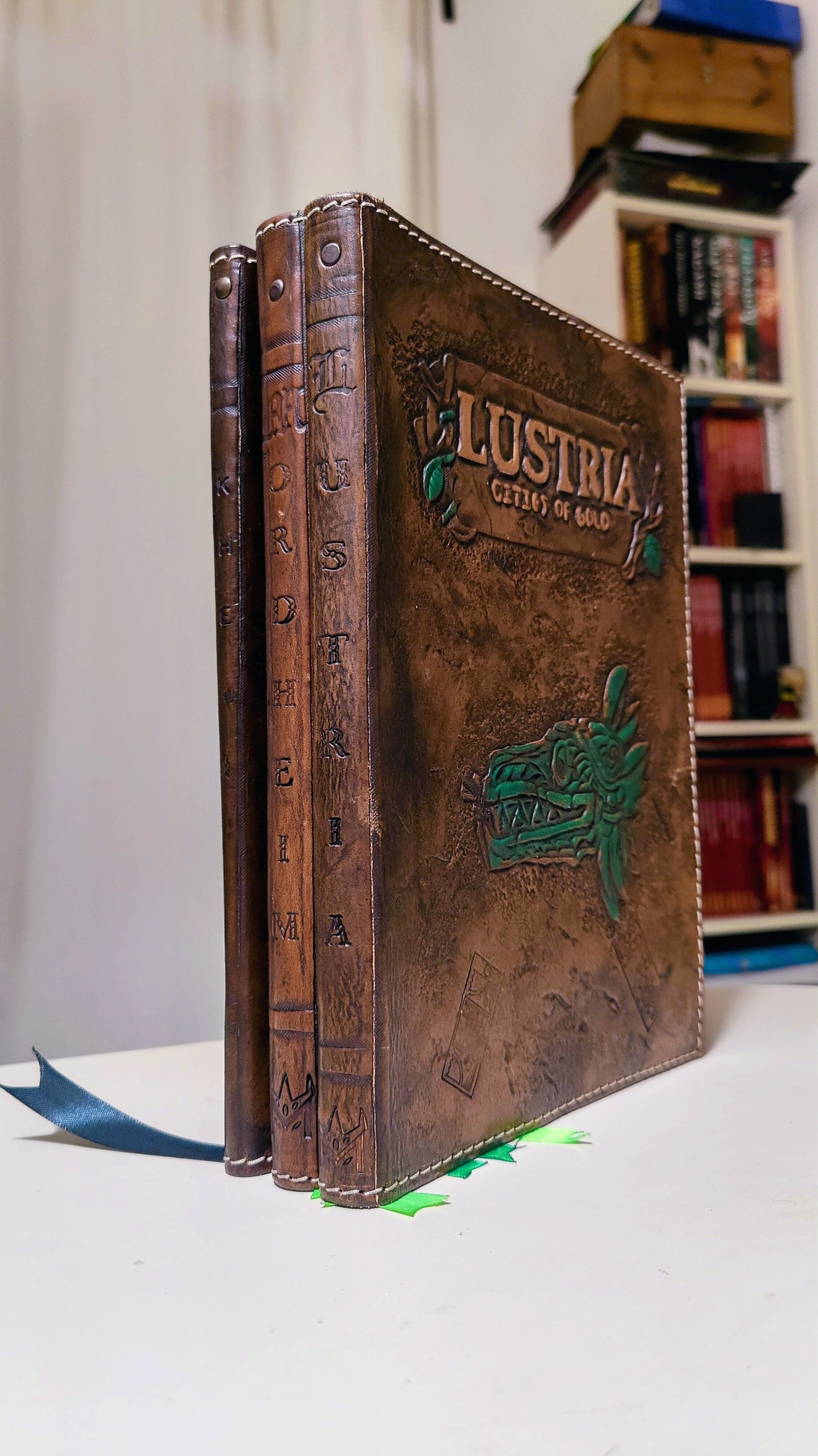 Aged leather book cover with hand-carved details, ideal for a vintage-style RPG and LARP look. Lustria version