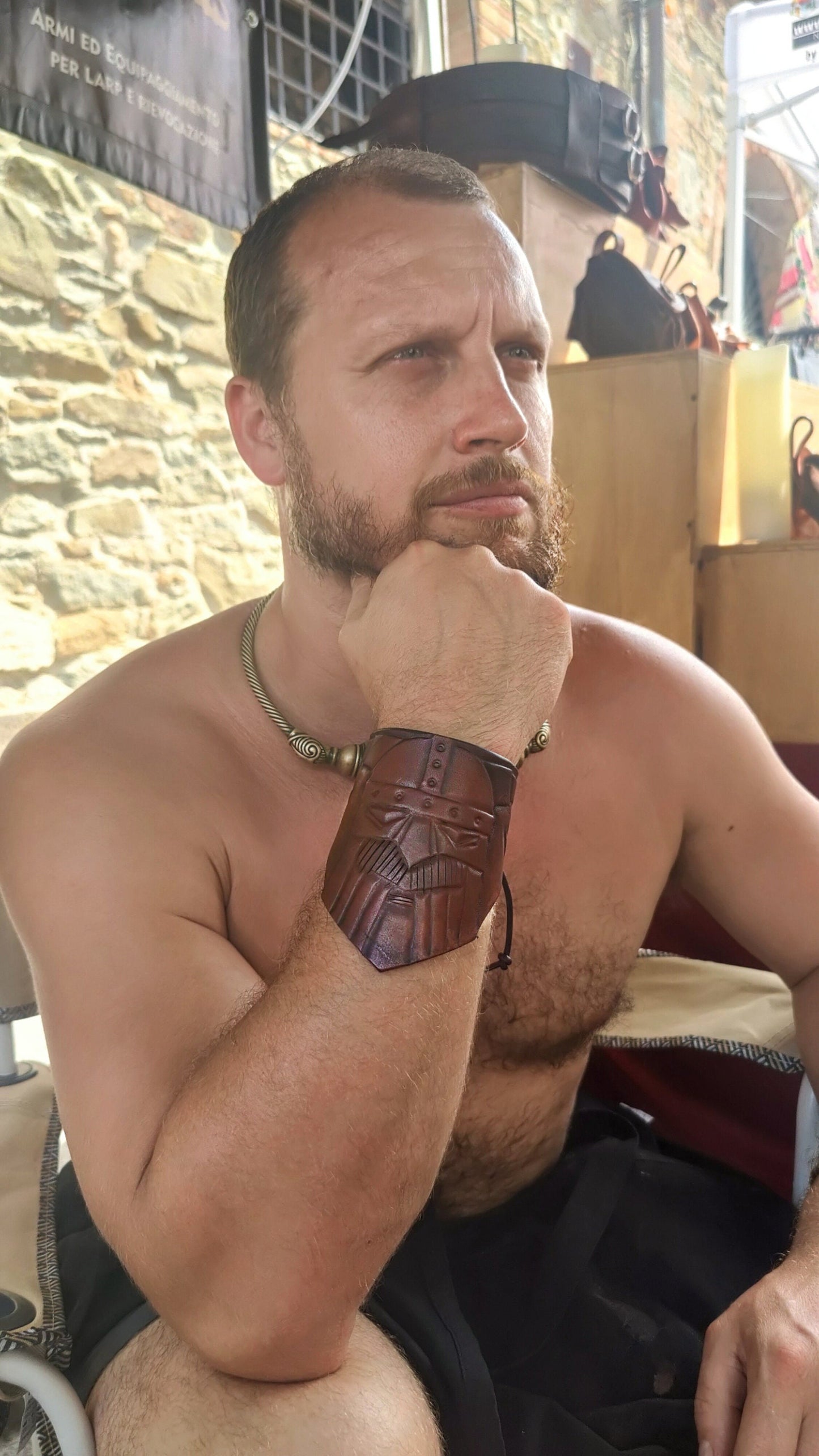 Adjustable Viking-style leather bracelet with hand-engraved Norse patterns, perfect for historical reenactments, LARP, and cosplay