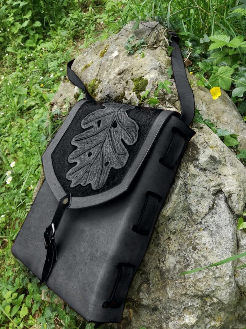 A stylish engraved leather shoulder bag in a boho-chic style, featuring a rectangular design and fully customizable details. Black version
