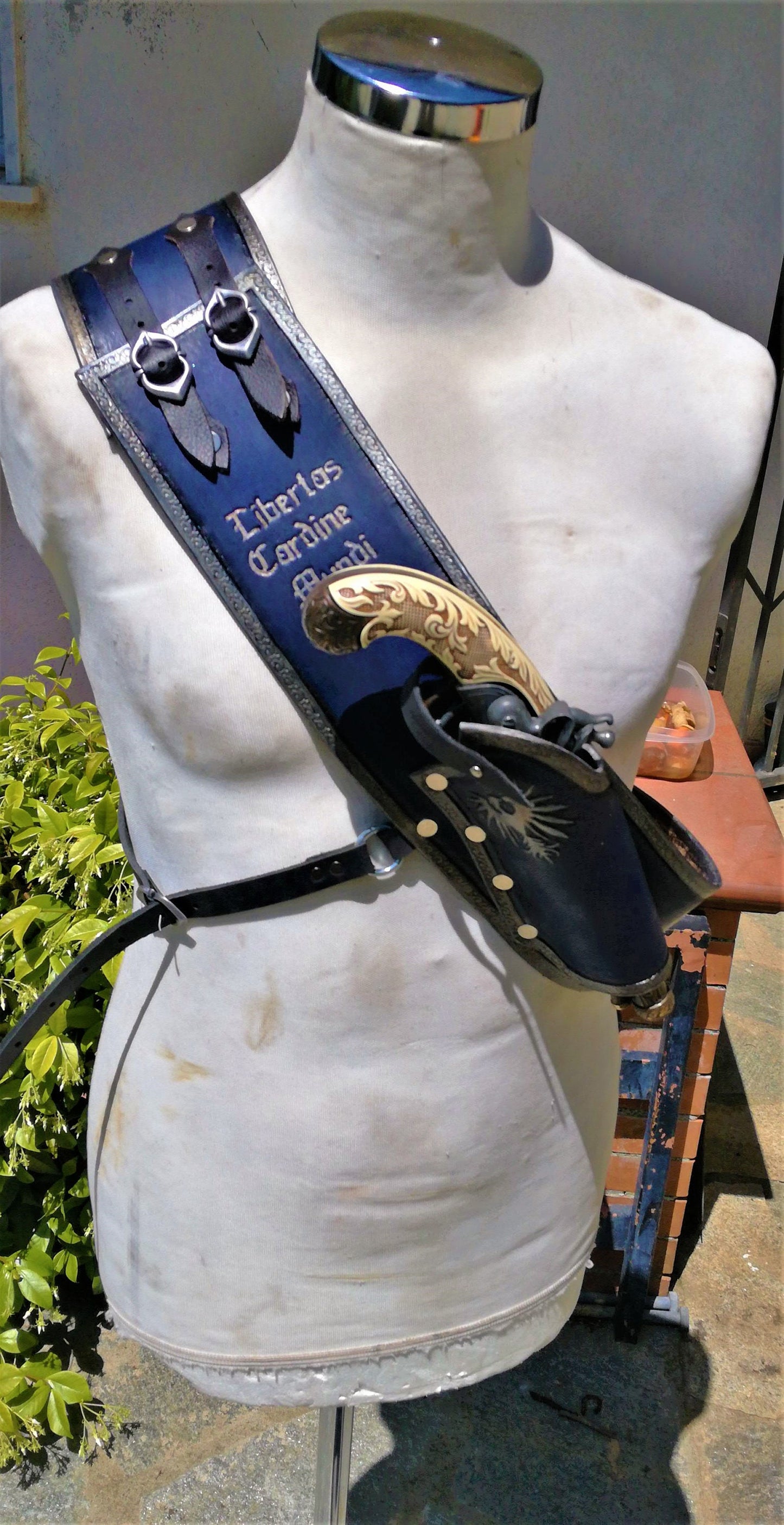 A unique blue leather bandolier. Custom-made designs available—contact for a personalized creation! WIth holster and engravings