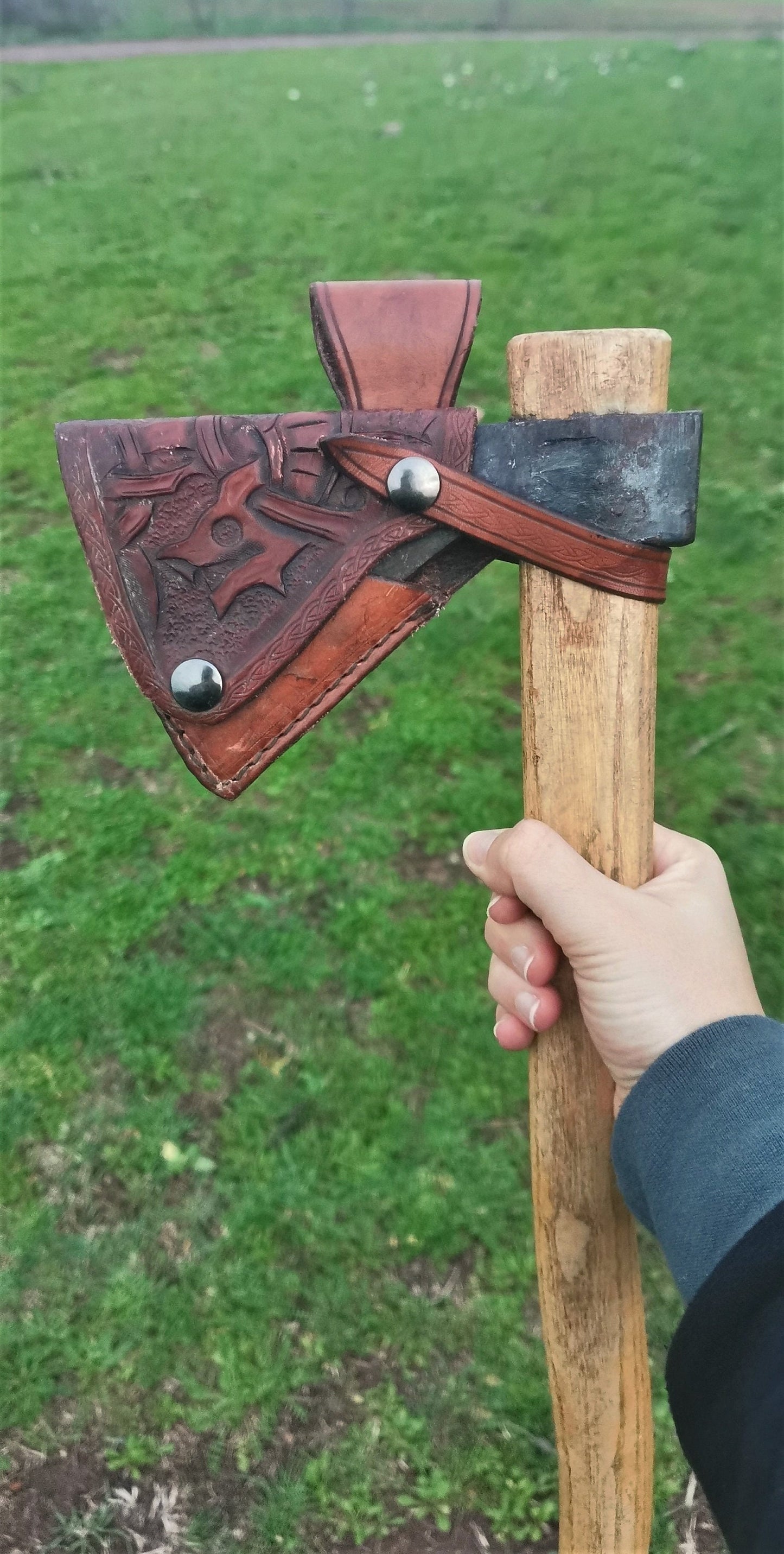 Handmade leather axe sheath with custom engraving, crafted from durable Italian vegetable-tanned leather for bushcraft.