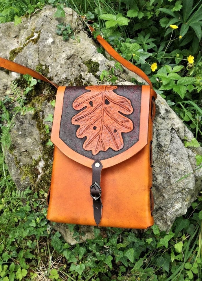 A handcrafted Italian leather tote bag, engraved with leaf patterns, handcrafted for elegance, durability, and personalization.