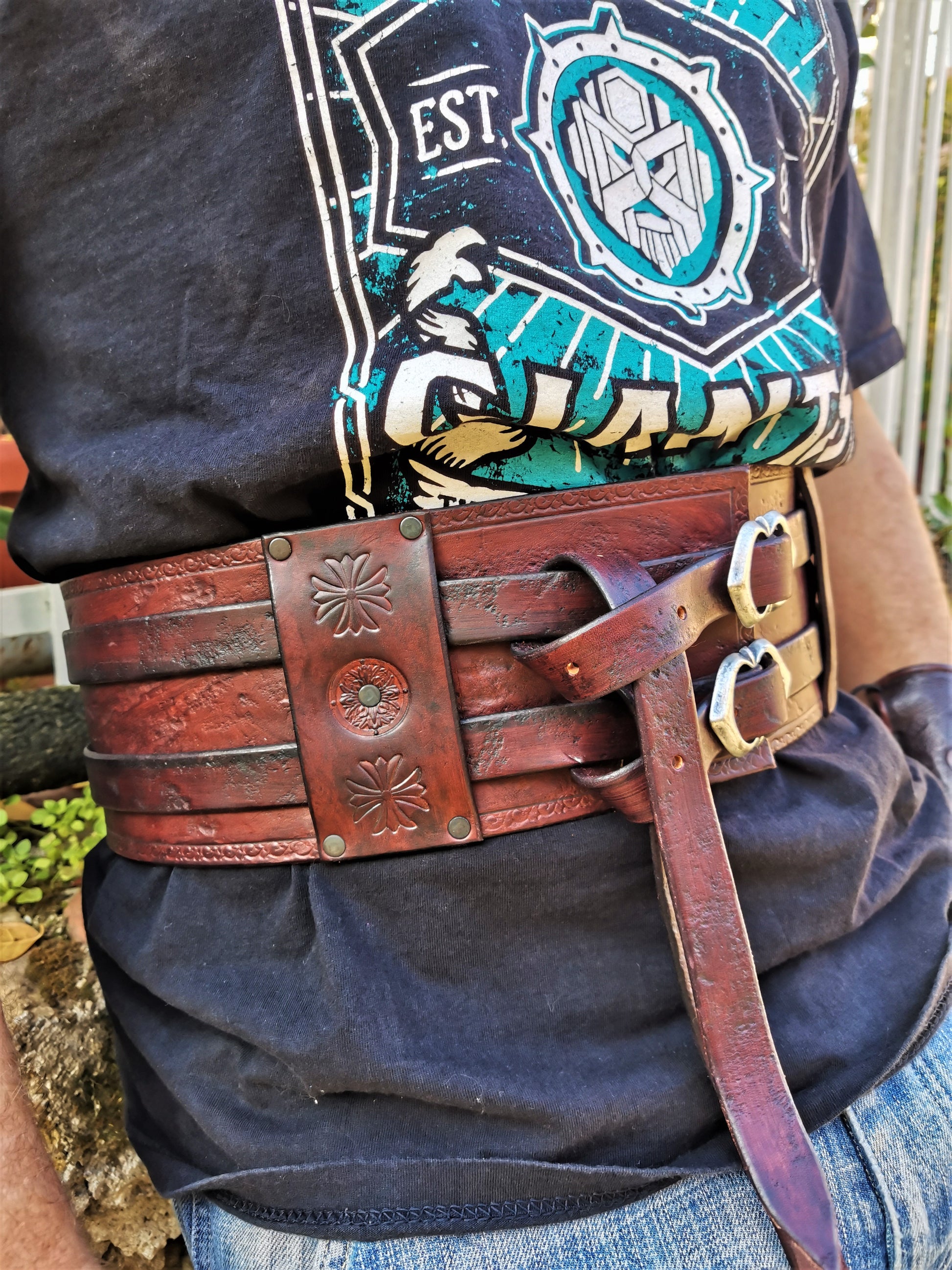 Explore our artisan-crafted leather belt featuring a double buckle design and intricate Celtic details. Ideal for various events or fitness