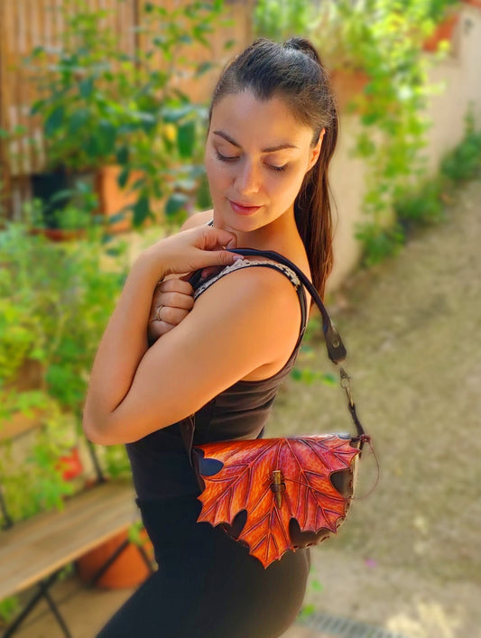 Lifestyle image showing the maple leaf leather bag being carried outdoors, highlighting its practicality and style