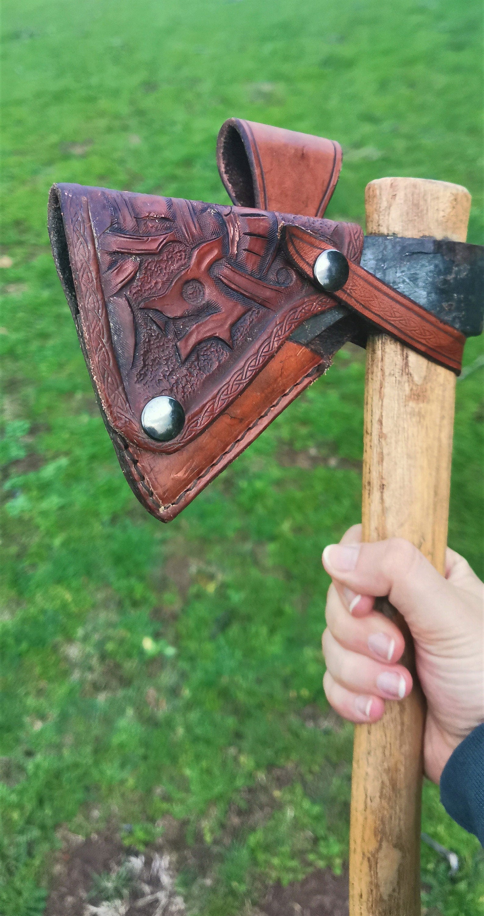 Custom leather axe cover, hand-engraved and designed for ultimate protection, perfect for bushcraft and outdoor adventures