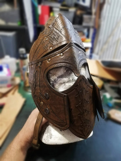 Unique leather battle helm with intricate details and custom shape. Designed for fantasy and historical warriors.