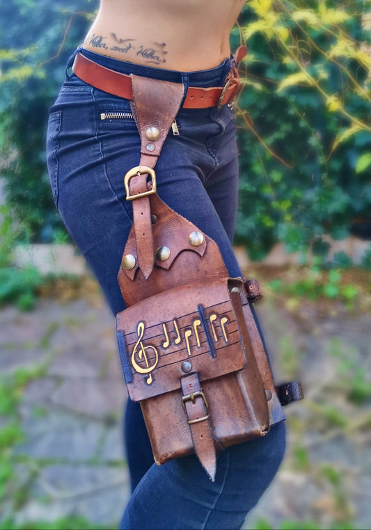 Handmade custom leather leg bag with engraved design, made from durable Italian vegetable-tanned leather. 