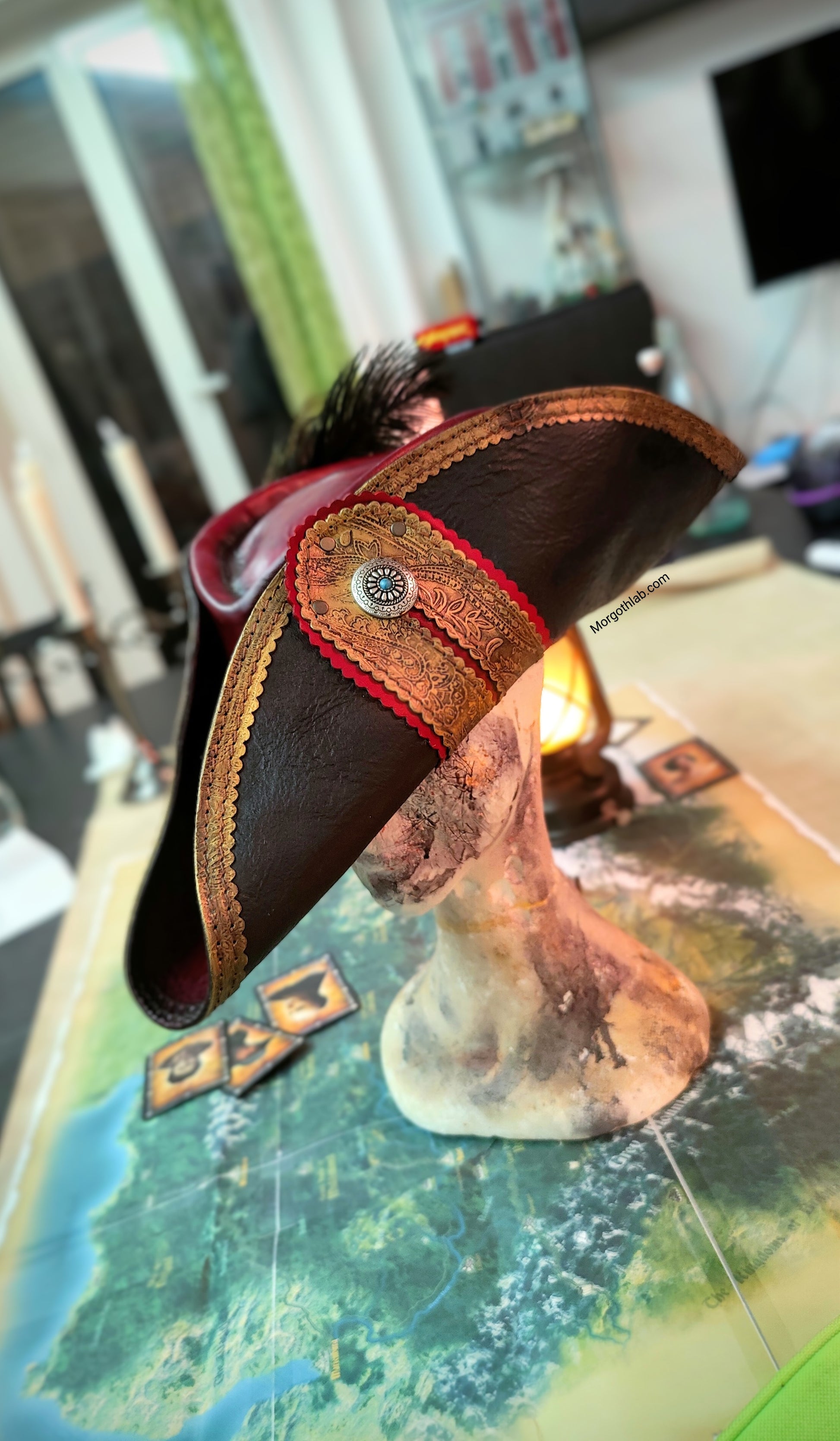 Close-up of a leather pirate hat with decorative elements on a map background