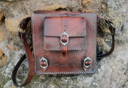 Fantasy-inspired leather shoulder bag with medieval-style engravings, adjustable strap, and durable handcrafted design