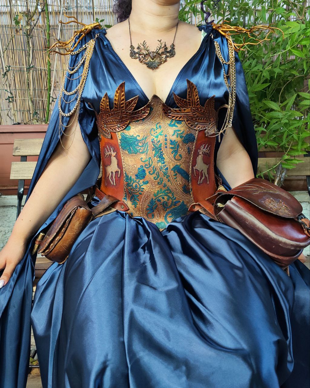 Medieval-inspired leather corset featuring reindeer and gold leaf engravings, designed for cosplay and LARP characters