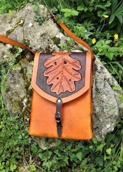 A handcrafted Italian leather tote bag, engraved with leaf patterns, handcrafted for elegance, durability, and personalization.