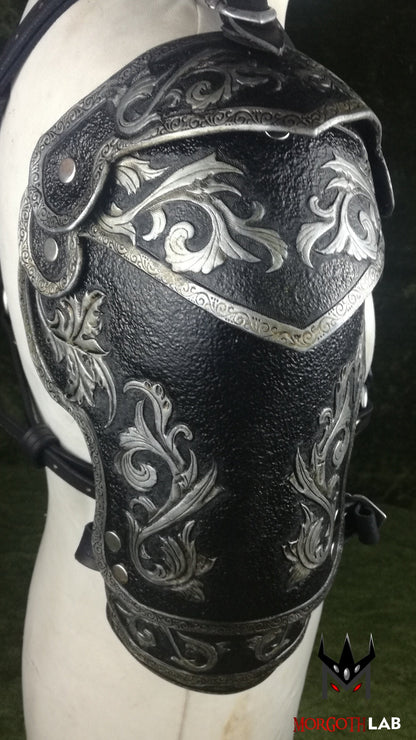A sophisticated black and silver leather pauldron, designed for knights, warriors, and elite fantasy characters. The engraved patterns and fine craftsmanship add an air of nobility, making it perfect for high-class LARP costumes.